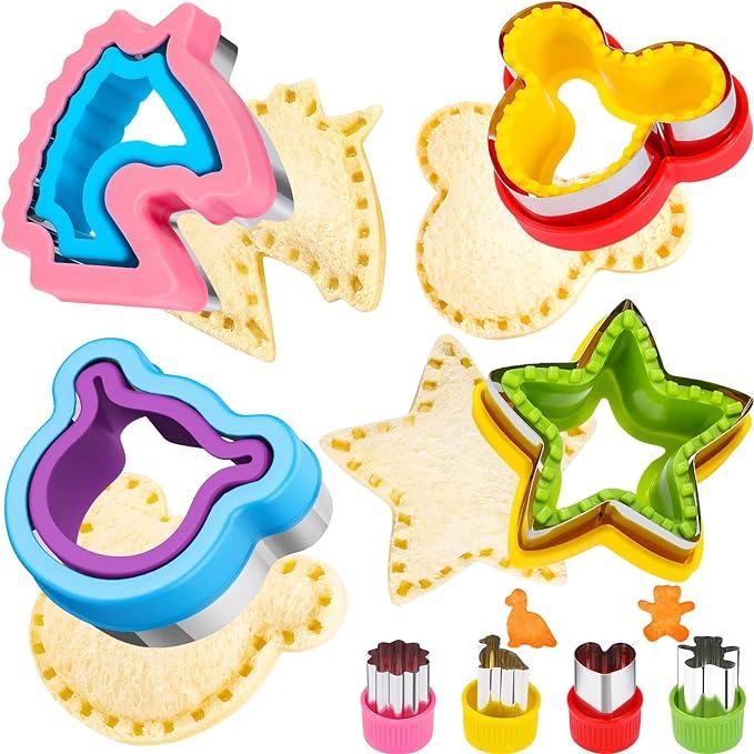 Set of colorful cookie cutters with shaped cookies on a white background